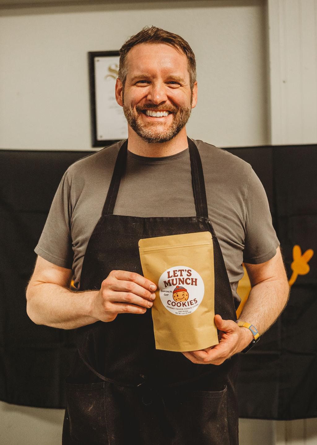 Alex holding a Let's Munch Cookies bag